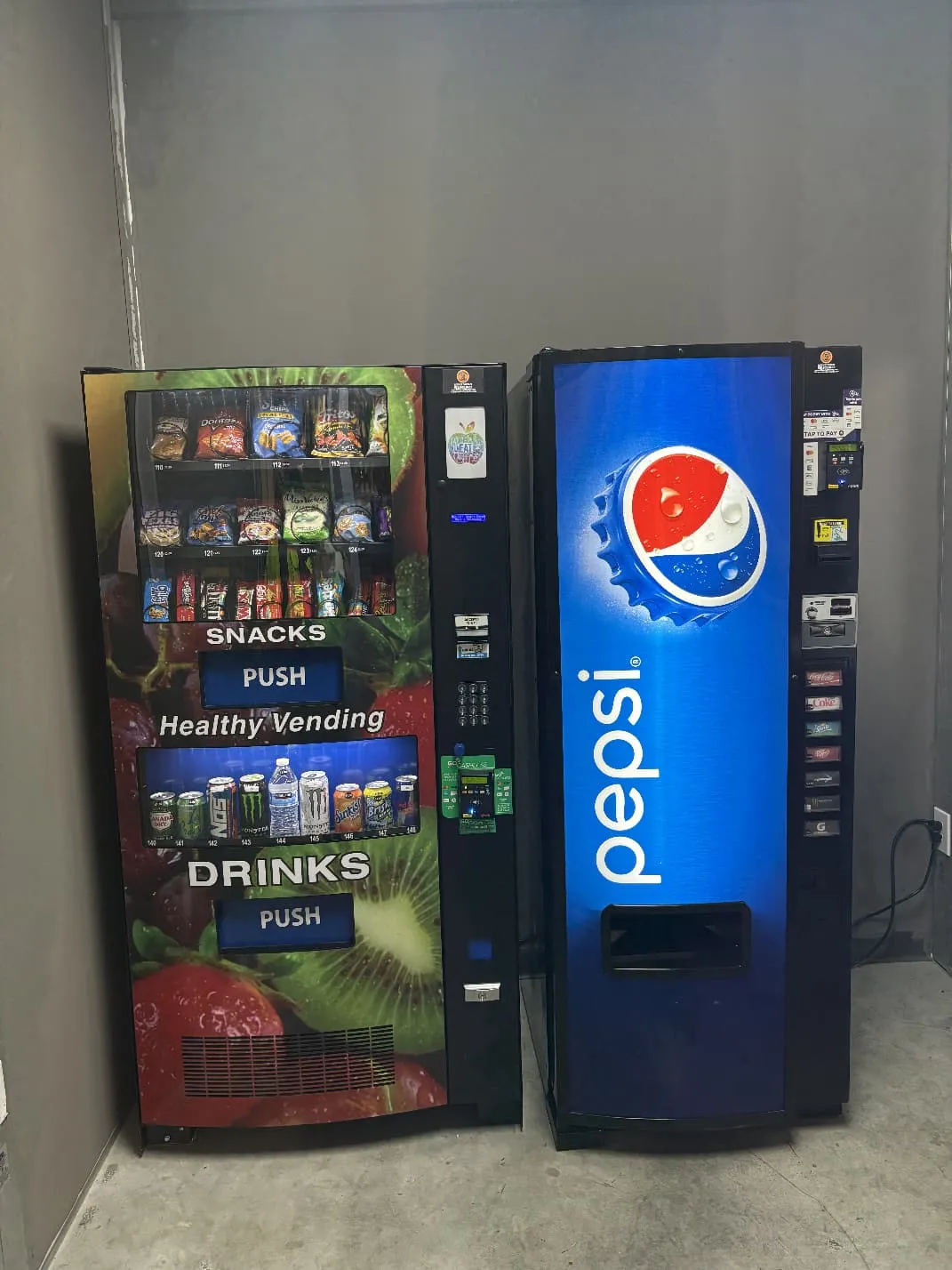 Healthy vending combo machine with snack and drink sections next to a Pepsi beverage machine