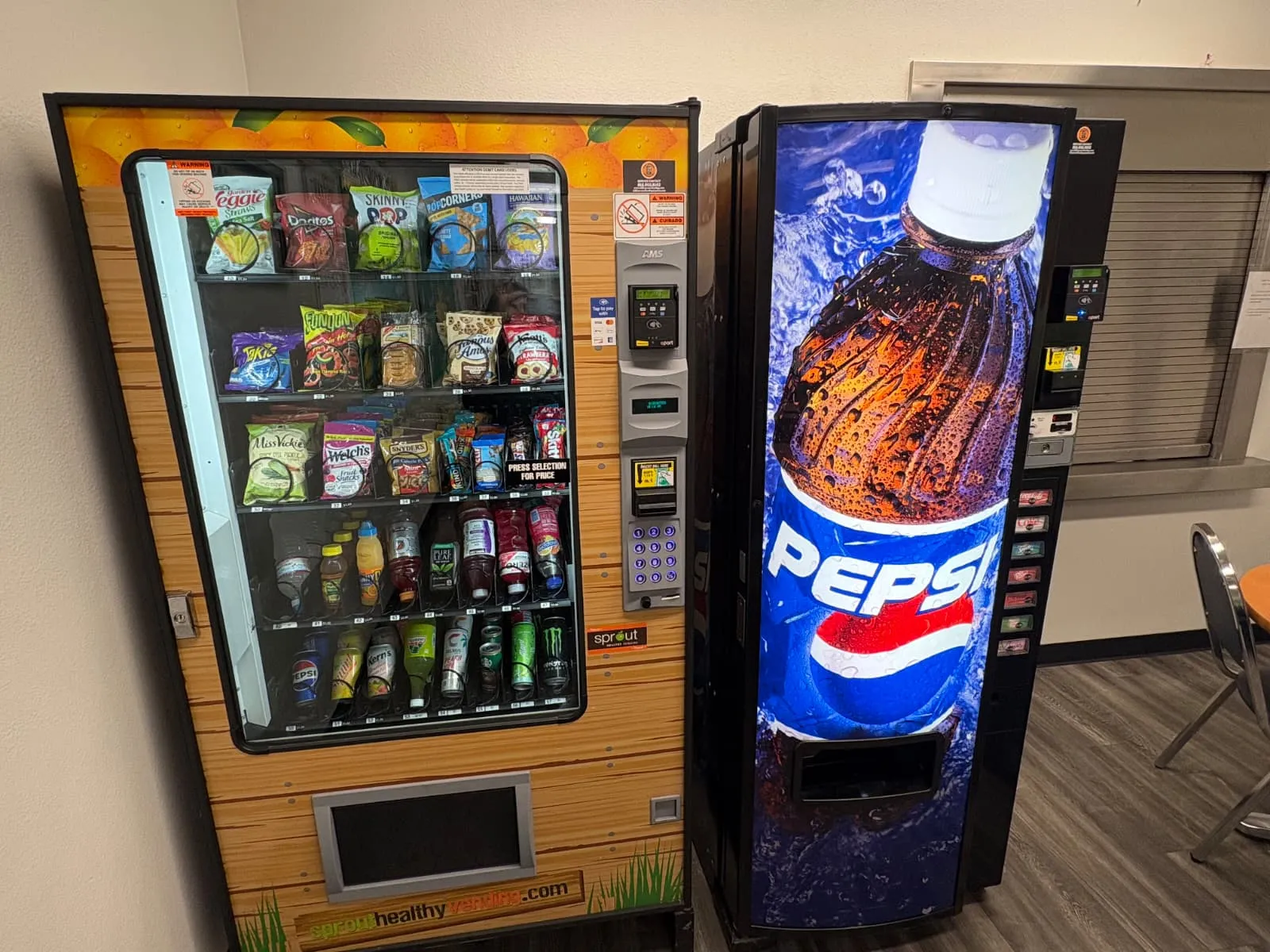 Healthy vending machine stocked with veggie straws, baked chips and better-for-you snacks beside a Pepsi machine Healthy vending machine stocked with veggie straws, baked chips and better-for-you snacks beside a Pepsi machine