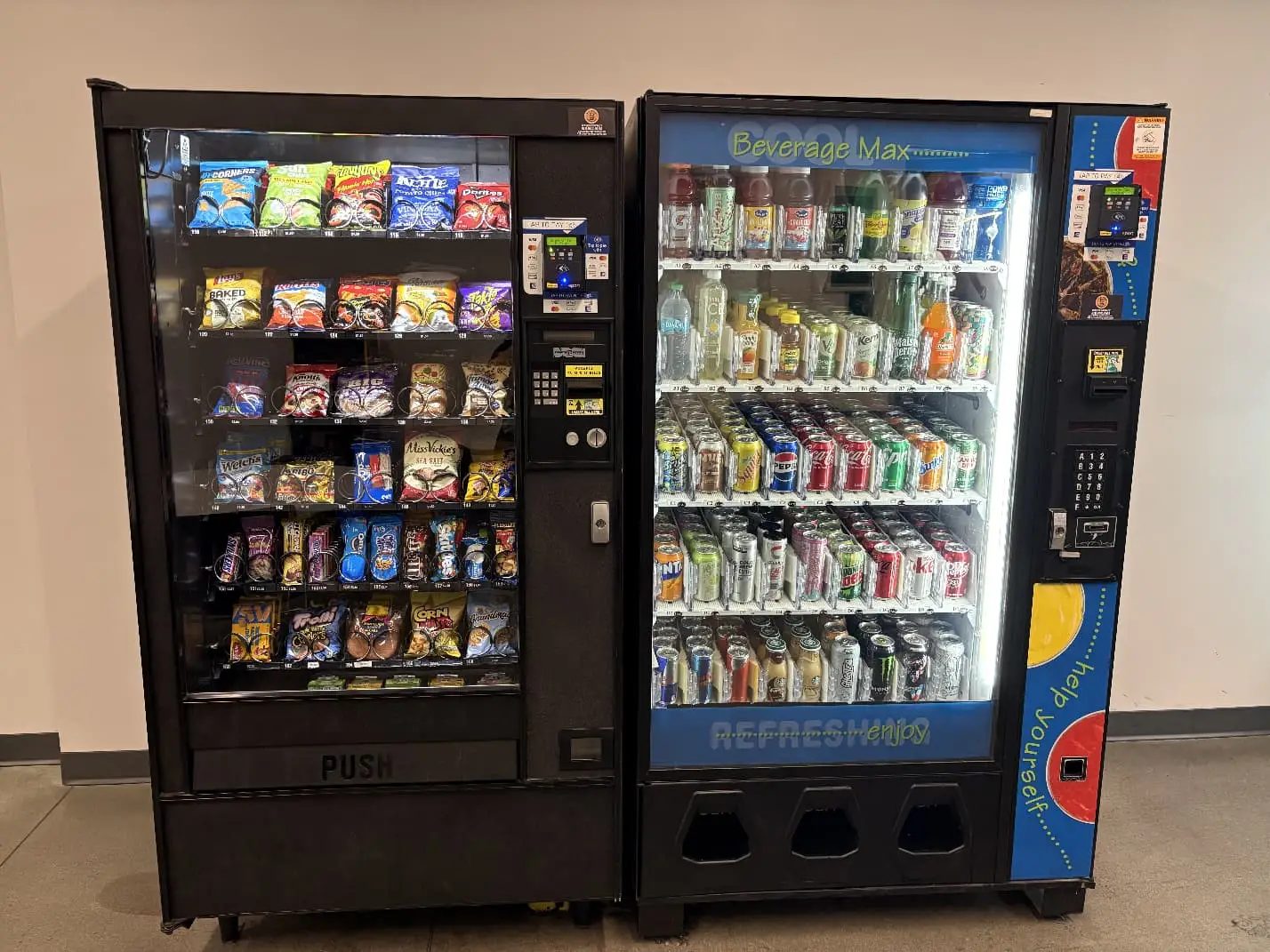 Snack and beverage vending machines set up side by side at a customer facility after delivery