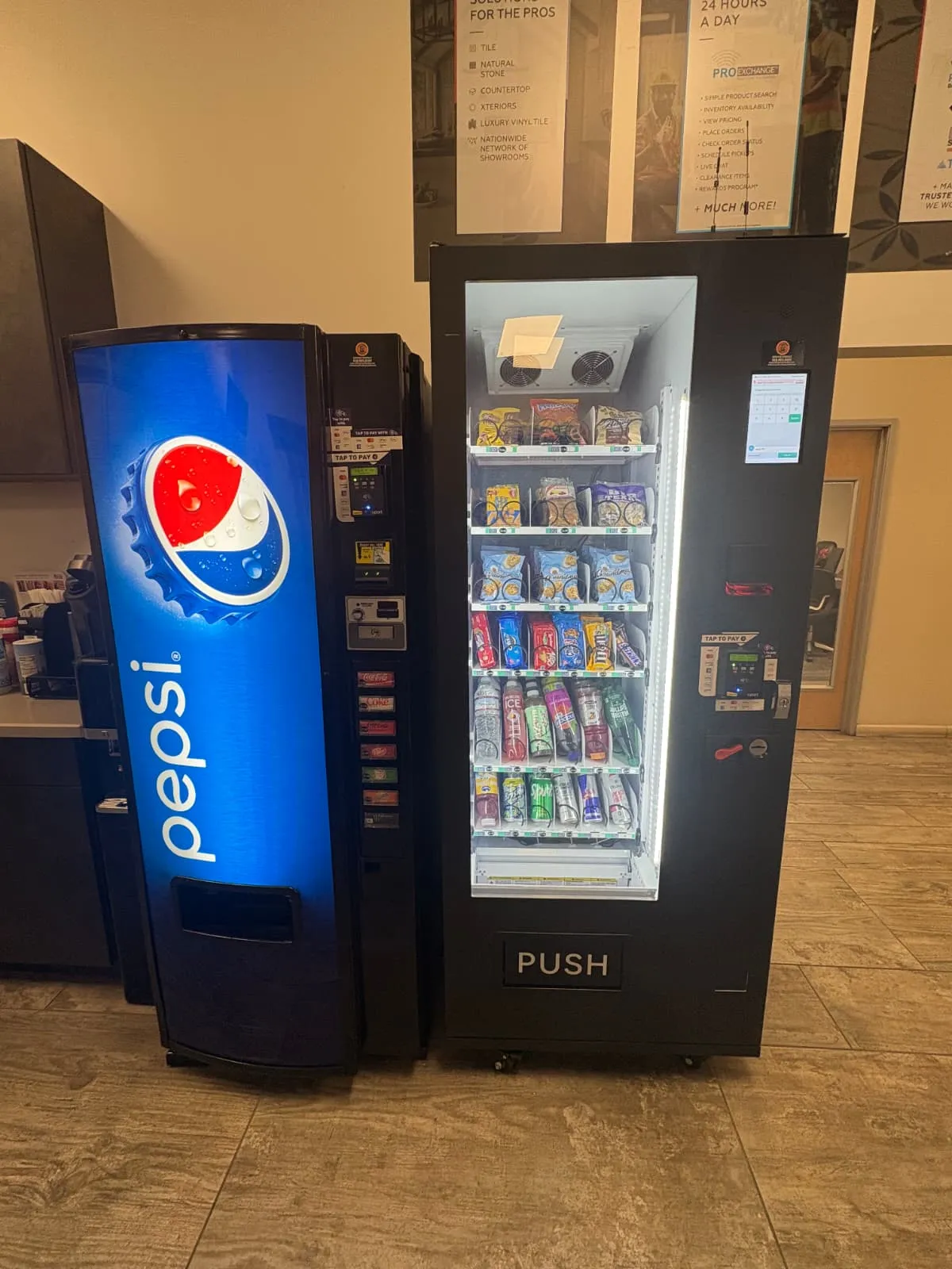 Pepsi beverage vending machine and glass-front snack machine installed in a showroom breakroom