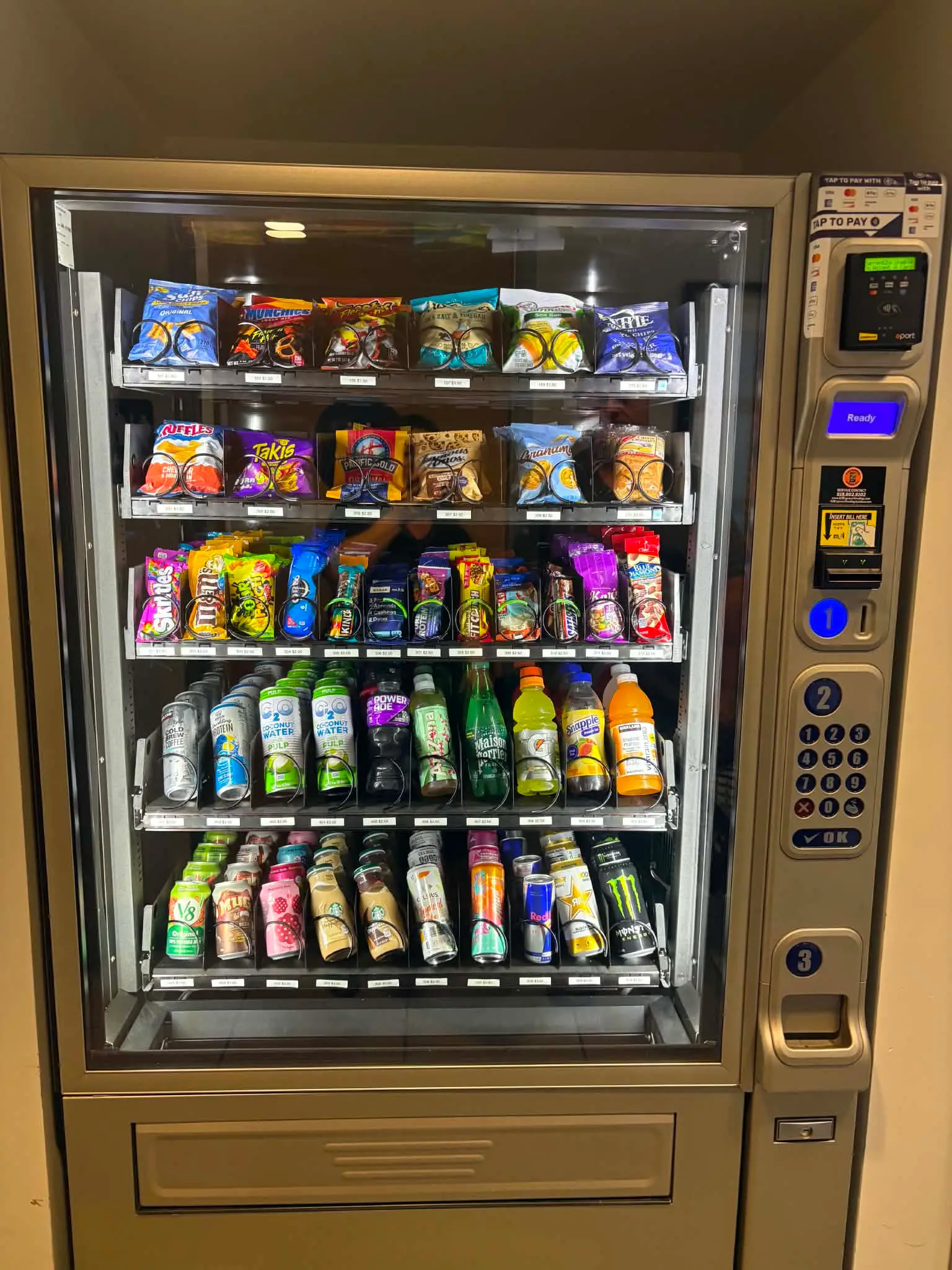 American-made glass-front combo vending machine with a steel cabinet, five stocked shelves of snacks and drinks, numeric keypad and ePort tap-to-pay card reader